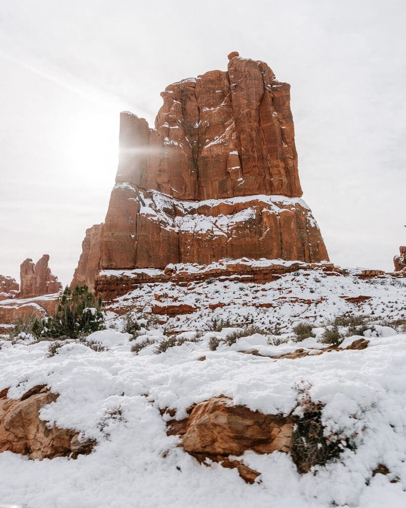 arches national park orange rock formationcovered in winter snow