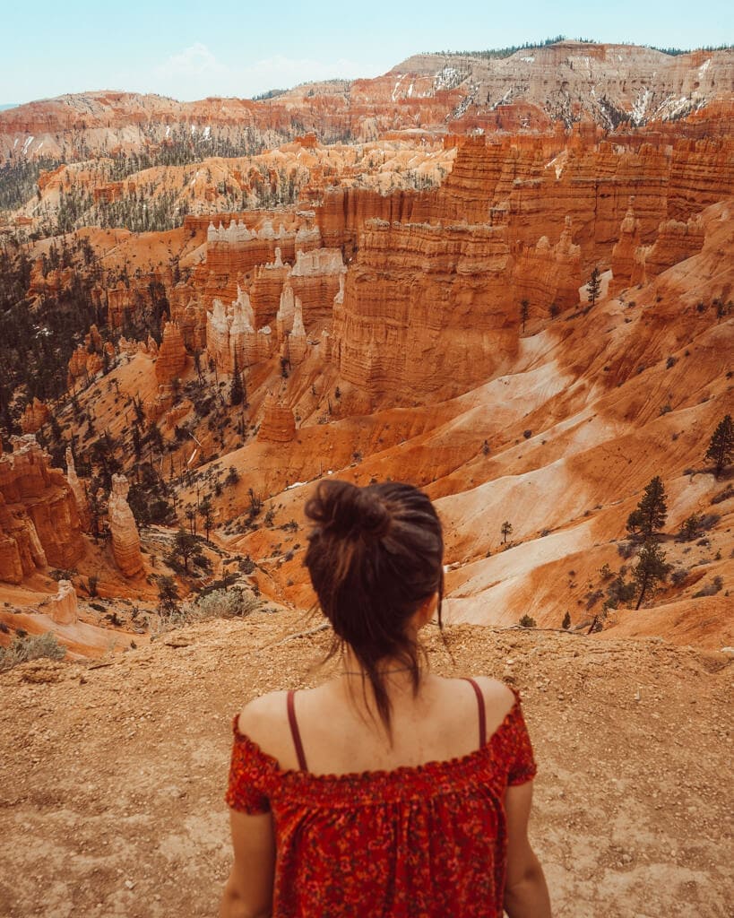 female looking at the orange rocks over sunrise point in bryce canyon national park